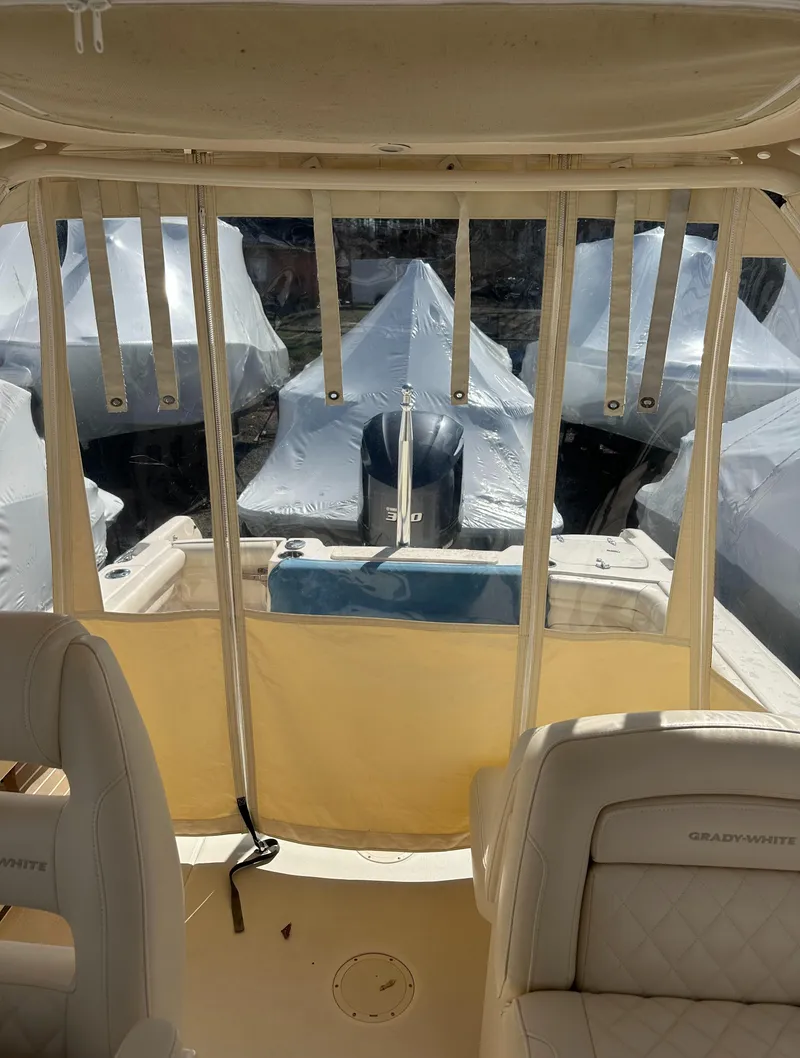 Slide: The Image of 2018 Grady-White Freedom 255 boat interior with covered engine view. - 23