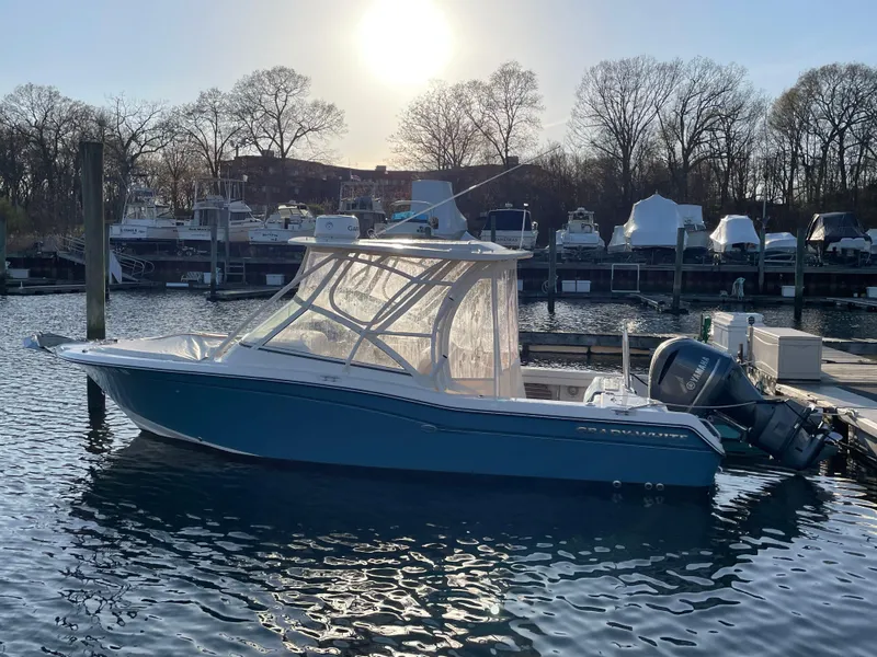Slide: The Image of 2018 Grady-White Freedom 255 boat docked in marina at sunset. - 27