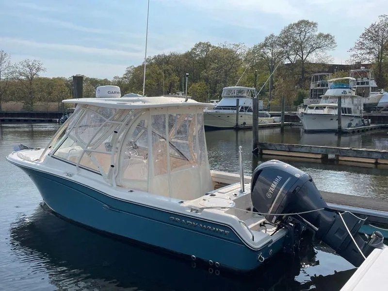 Slide: The Image of 2018 Grady-White Freedom 255 boat docked with Yamaha outboard motor. - 28