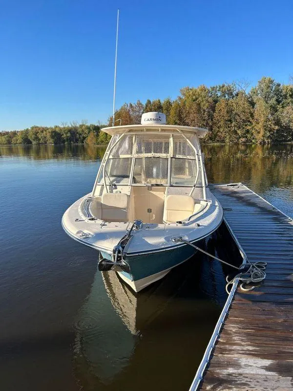 Slide: The Image of 2018 Grady-White Freedom 255 boat docked on a calm lake. - 29