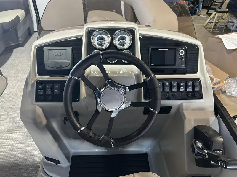 Slide: The Image of 2025 Sylvan Mirage X X3 CLZ boat dashboard with steering wheel and control panel. - 11