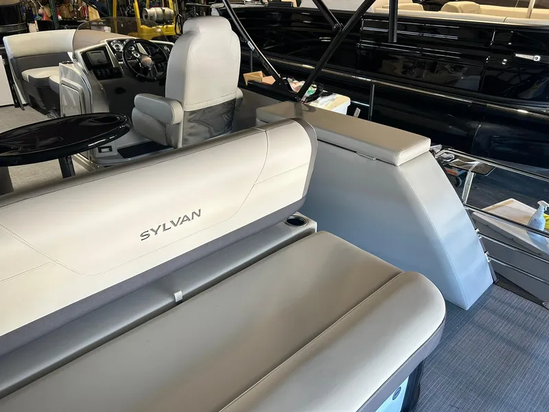 Slide: The Image of 2025 Sylvan Mirage X X3 CLZ boat interior with seating and steering console. - 13