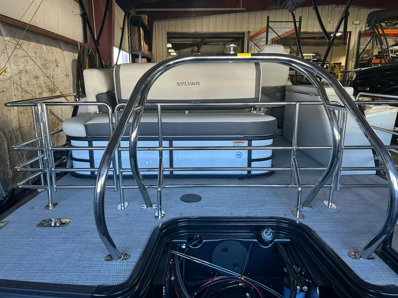 Slide: The Image of 2025 Sylvan Mirage X X3 CLZ pontoon boat interior with seating and metal railings. - 17