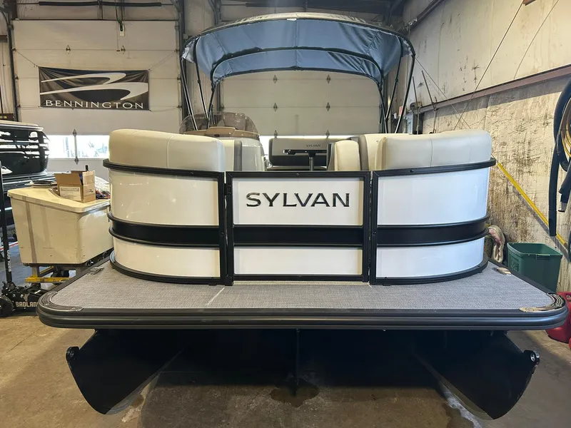 Slide: The Image of 2025 Sylvan Mirage X X3 CLZ pontoon boat in a garage setting. - 2