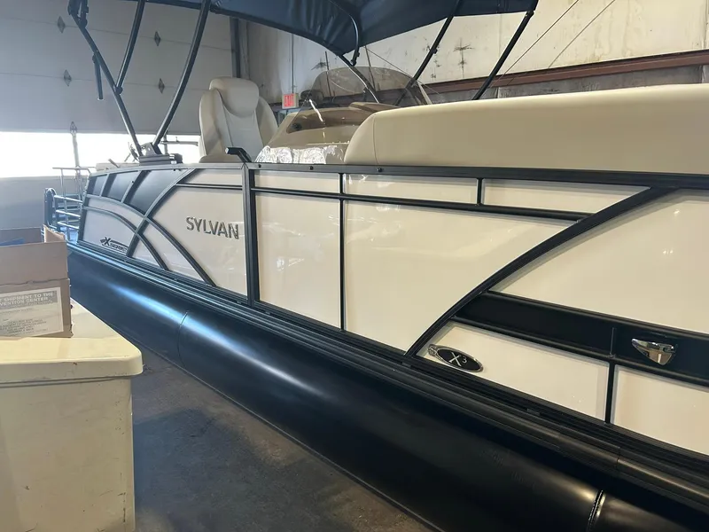 Slide: The Image of 2025 Sylvan Mirage X X3 CLZ pontoon boat in a warehouse setting. - 4