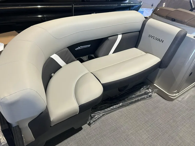Slide: The Image of 2025 Sylvan Mirage X X3 CLZ boat seating, featuring sleek gray upholstery and modern design. - 7