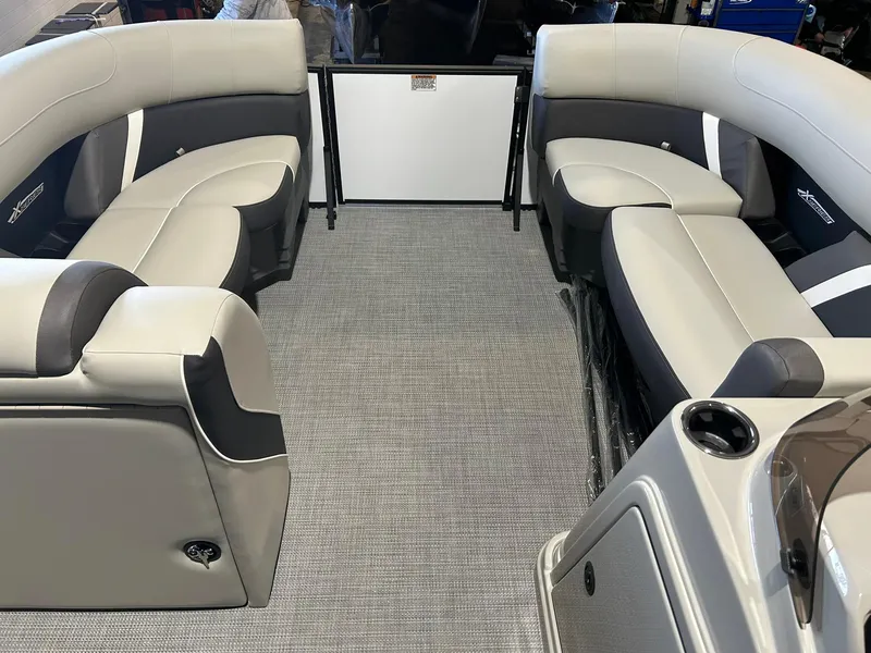 Slide: The Image of 2025 Sylvan Mirage X X3 CLZ boat interior with gray seating and carpet. - 9