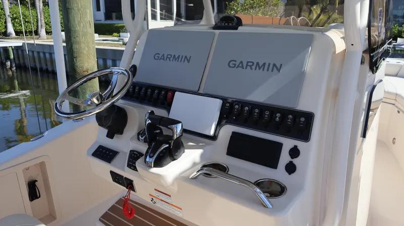 Slide: The Image of 2023 Grady-White 281 Coastal Explorer boat dashboard with Garmin displays. - 18
