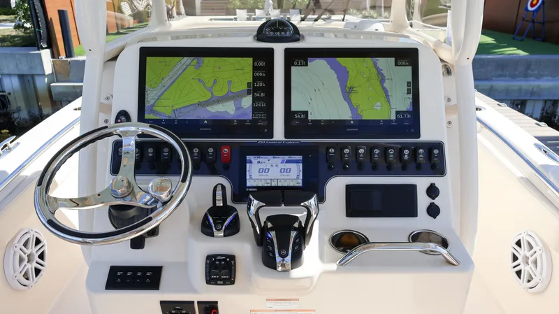 Slide: The Image of 2023 Grady-White 281 Coastal Explorer helm with dual navigation screens and controls. - 19