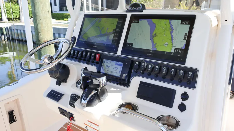 Slide: The Image of 2023 Grady-White 281 Coastal Explorer boat dashboard with dual navigation screens. - 21