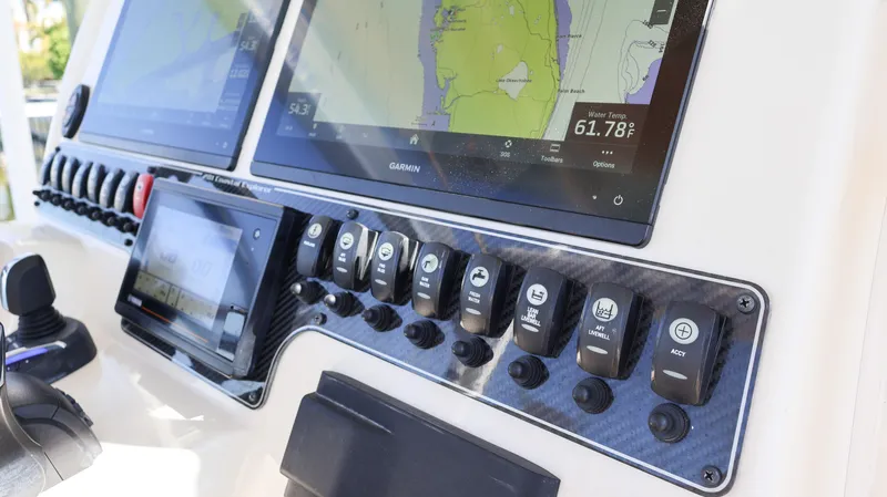Slide: The Image of Control panel of 2023 Grady-White 281 Coastal Explorer boat with navigation screens. - 22