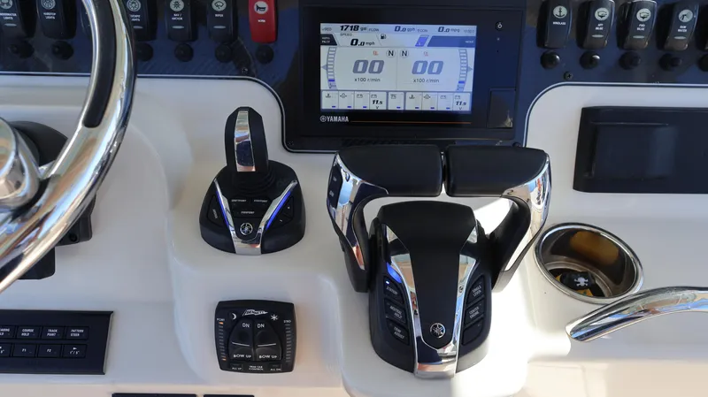 Slide: The Image of Control panel of 2023 Grady-White 281 Coastal Explorer boat with steering and throttle controls. - 24