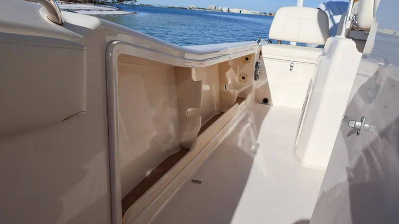Slide: The Image of 2023 Grady-White 281 Coastal Explorer boat interior with storage compartment, near water. - 28