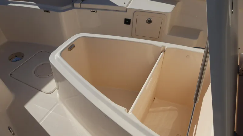 Slide: The Image of 2023 Grady-White 281 Coastal Explorer boat storage compartment, beige interior. - 29