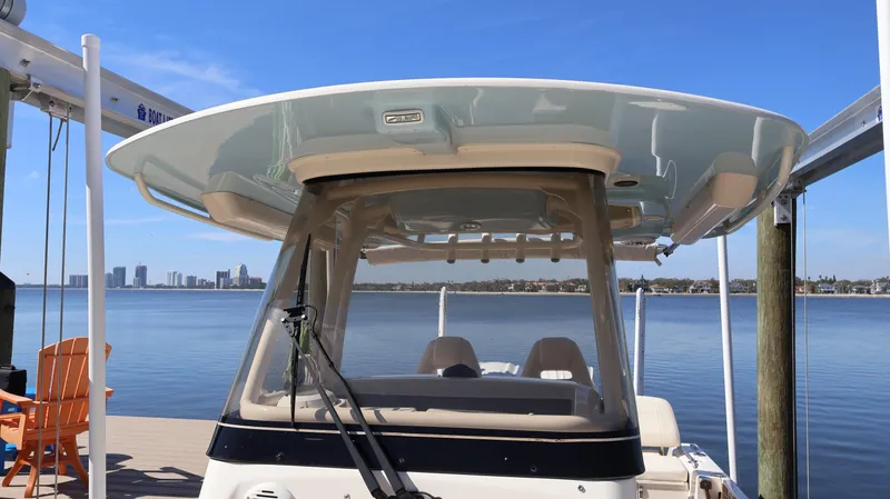 Slide: The Image of 2023 Grady-White 281 Coastal Explorer boat docked with city skyline in background. - 32