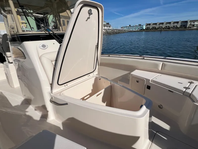 Slide: The Image of 2023 Grady-White 281 Coastal Explorer boat with open storage compartment by the water. - 41