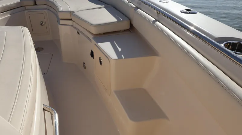 Slide: The Image of 2023 Grady-White 281 Coastal Explorer boat interior with cushioned seating and storage compartments. - 43