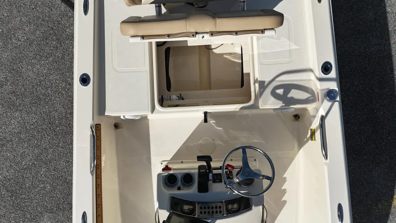 Slide: The Image of 2022 Scout 177 Sport boat interior with steering wheel and seating, top view. - 10