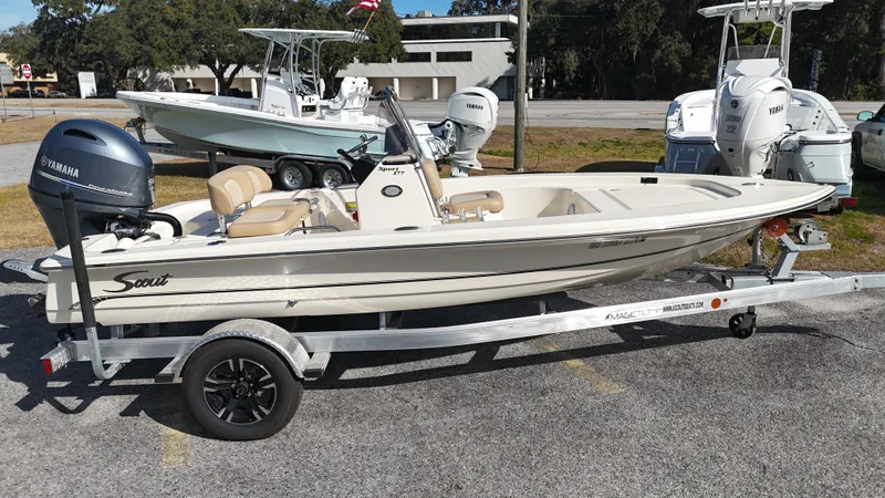 Slide: The Image of 2022 Scout 177 Sport boat on trailer with Yamaha engine, parked outdoors. - 2