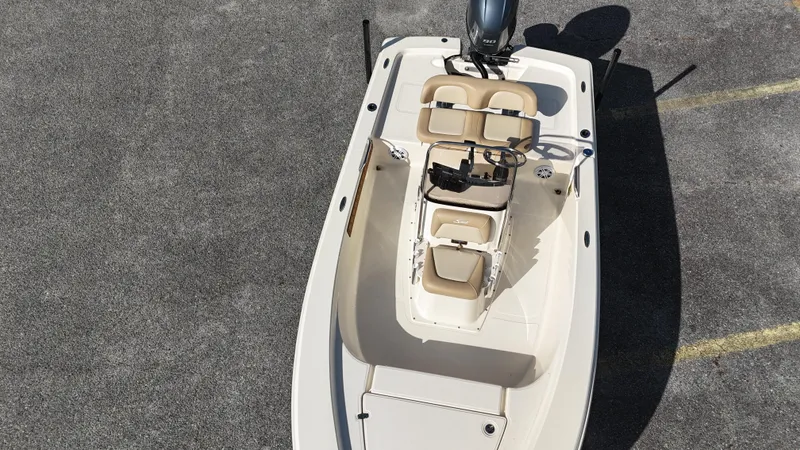 Slide: The Image of 2022 Scout 177 Sport boat, aerial view, beige seating, parked on asphalt. - 6