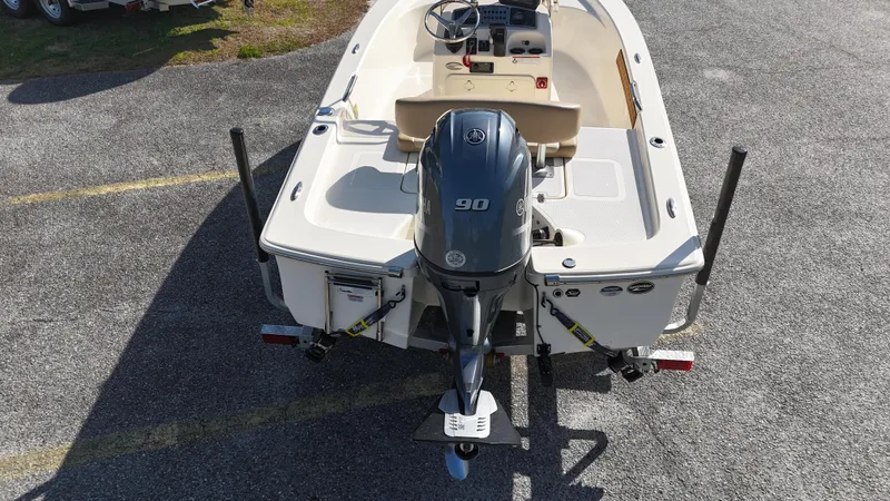 Slide: The Image of 2022 Scout 177 Sport boat with 90 HP outboard motor, viewed from the rear. - 8