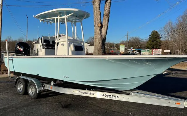 Slide: The Image of 2024 Tidewater 2300 Carolina Bay boat on trailer, parked outdoors. - 1