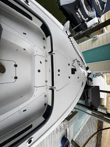 Slide: The Image of 2024 Tidewater 2300 Carolina Bay boat, top view, docked near water. - 14