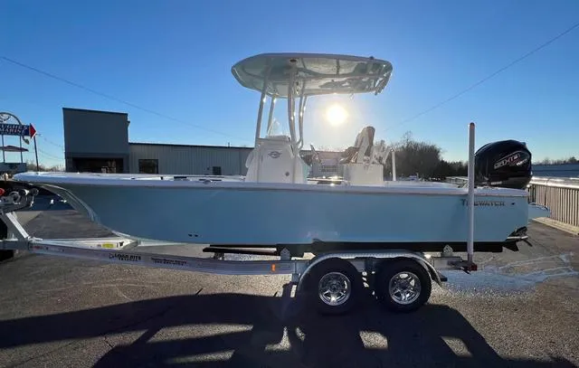 Slide: The Image of 2024 Tidewater 2300 Carolina Bay boat on trailer, sunlit background. - 4