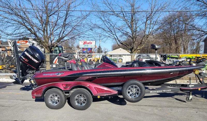 Slide: The Image of 2012 Ranger Z519 Comanche bass boat on trailer, parked outdoors. - 0