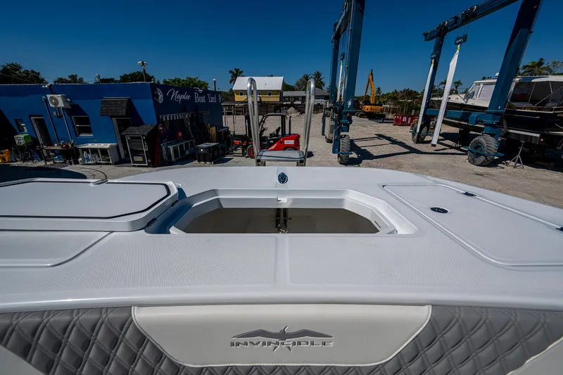 Slide: The Image of 2025 Invincible 33 Catamaran at dockyard, showcasing sleek design and spacious deck. - 10