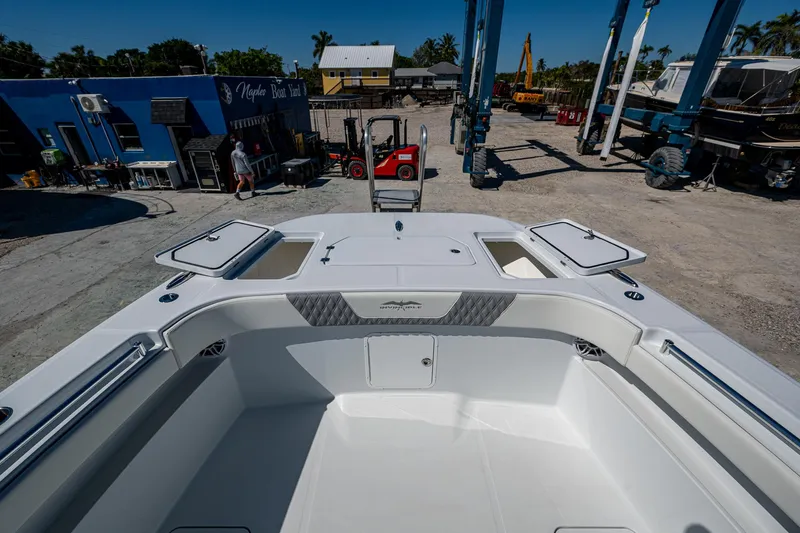 Slide: The Image of 2025 Invincible 33 Catamaran at dock, showcasing spacious deck and storage compartments. - 11