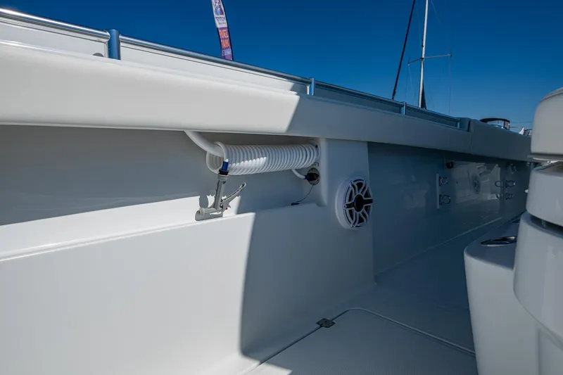 Slide: The Image of 2025 Invincible 33 Catamaran interior detail with speaker and hose, showcasing sleek design. - 12