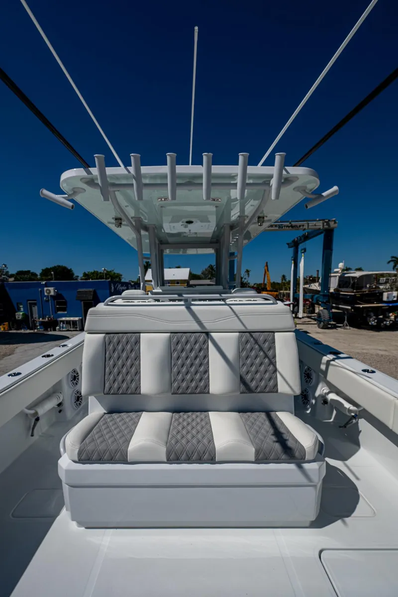 Slide: The Image of 2025 Invincible 33 Catamaran with cushioned seating and sleek design. - 18