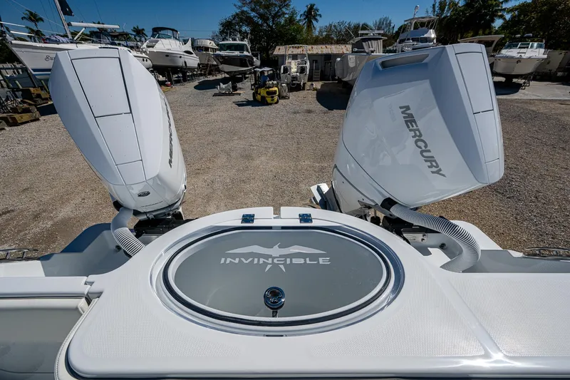 Slide: The Image of 2025 Invincible 33 Catamaran with dual Mercury outboard engines in a boatyard. - 20