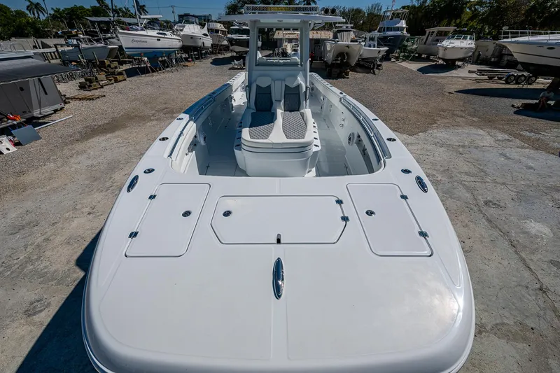 Slide: The Image of 2025 Invincible 33 Catamaran in a boatyard, showcasing sleek design and spacious deck. - 3