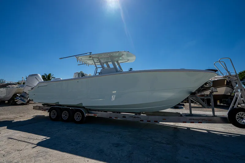 Slide: The Image of 2025 Invincible 33 Catamaran on trailer under clear blue sky. - 32