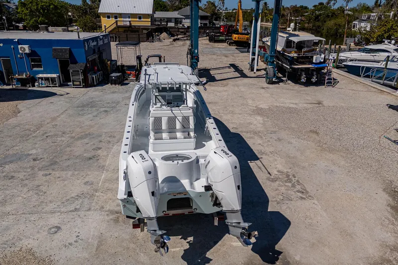 Slide: The Image of 2025 Invincible 33 Catamaran on dry dock, showcasing sleek design and twin engines. - 37