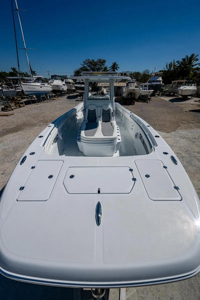 Slide: The Image of 2025 Invincible 33 Catamaran, sleek design, docked under clear blue sky. - 4