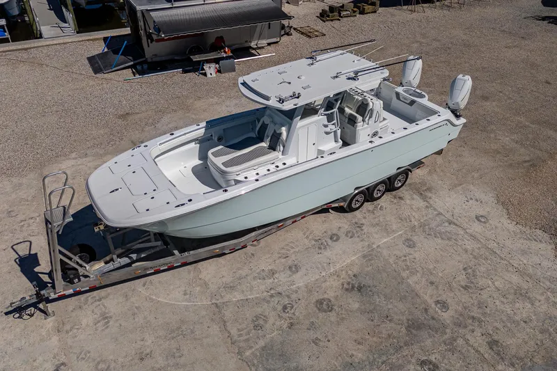 Slide: The Image of 2025 Invincible 33 Catamaran on trailer, aerial view, parked on concrete surface. - 41