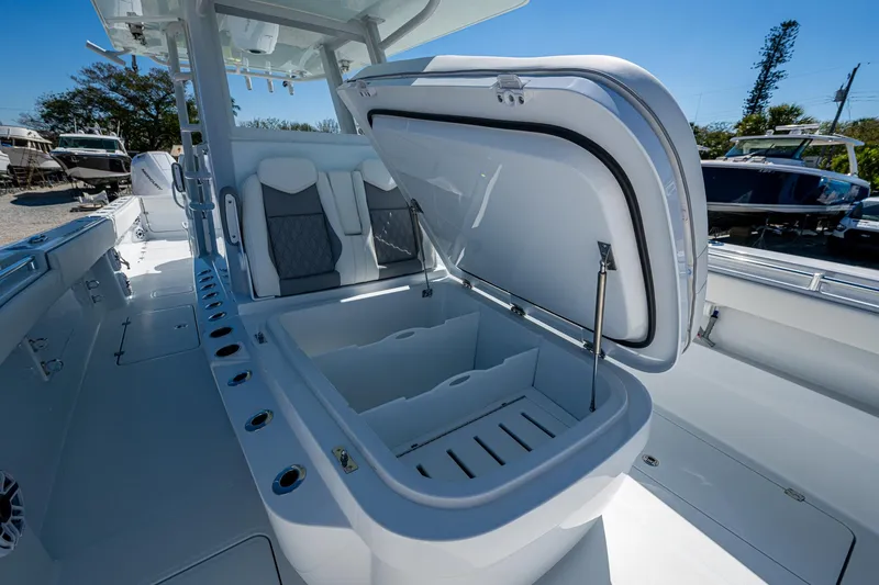Slide: The Image of 2025 Invincible 33 Catamaran with open storage compartment and seating, showcasing modern design. - 8