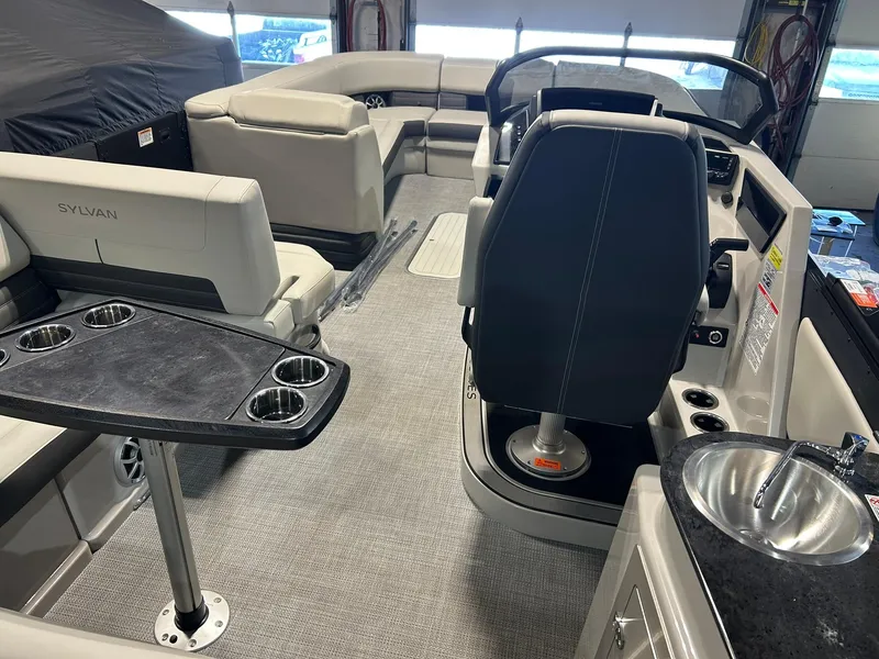 Slide: The Image of Interior of 2025 Sylvan G5 CLZ boat with seating, table, and helm. - 10
