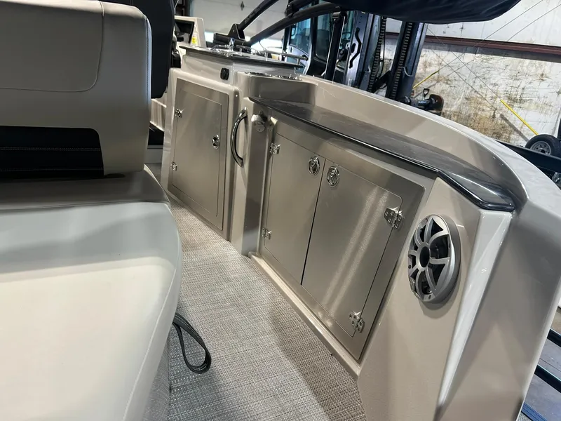 Slide: The Image of 2025 Sylvan G5 CLZ boat interior with storage cabinets and speaker. - 13