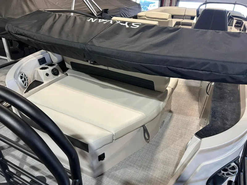 Slide: The Image of 2025 Sylvan G5 CLZ boat interior with cushioned seating and protective cover. - 14