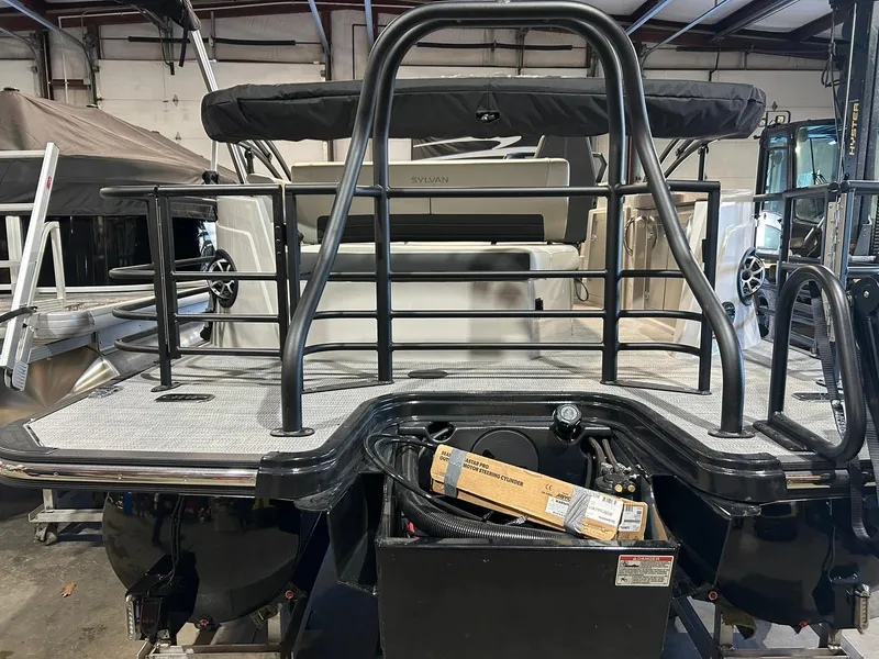 Slide: The Image of 2025 Sylvan G5 CLZ boat interior with railing and equipment in a storage facility. - 15