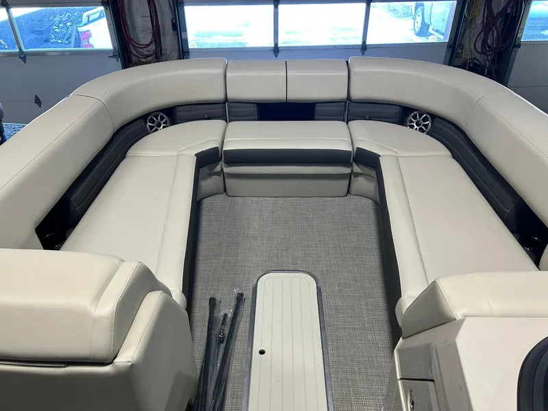 Slide: The Image of Luxurious seating area of 2025 Sylvan G5 CLZ pontoon boat in a garage setting. - 3