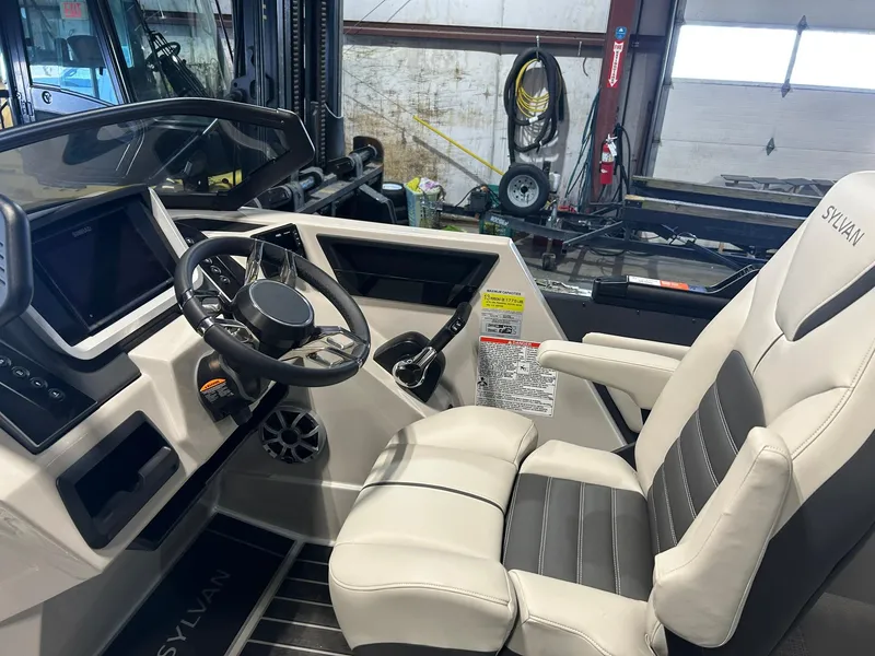 Slide: The Image of Interior of 2025 Sylvan G5 CLZ boat with modern steering and comfortable seating. - 8