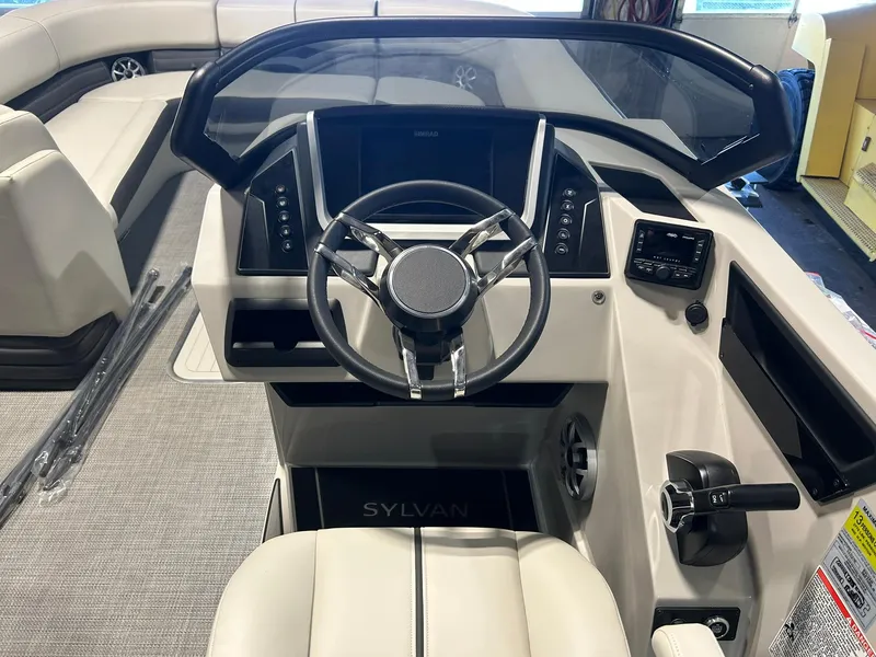 Slide: The Image of 2025 Sylvan G5 CLZ boat dashboard with modern steering wheel and control panel. - 9