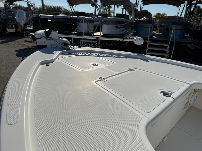 Slide: The Image of 2011 Mako 18 LTS Inshore boat deck with storage compartments and clean design. - 11