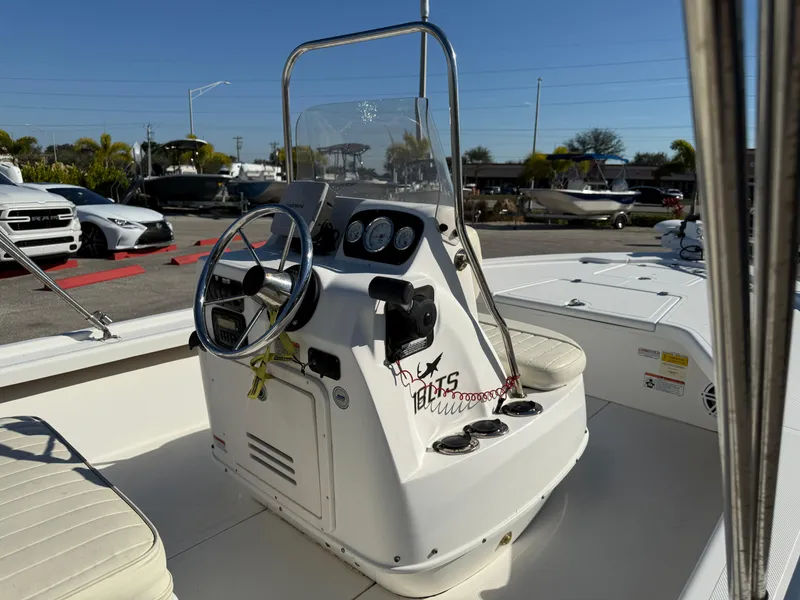 Slide: The Image of 2011 Mako 18 LTS Inshore boat console with steering wheel and gauges. - 15