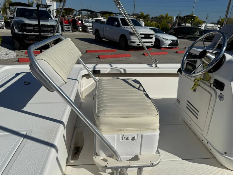 Slide: The Image of 2011 Mako 18 LTS Inshore boat interior with seating and steering wheel. - 16